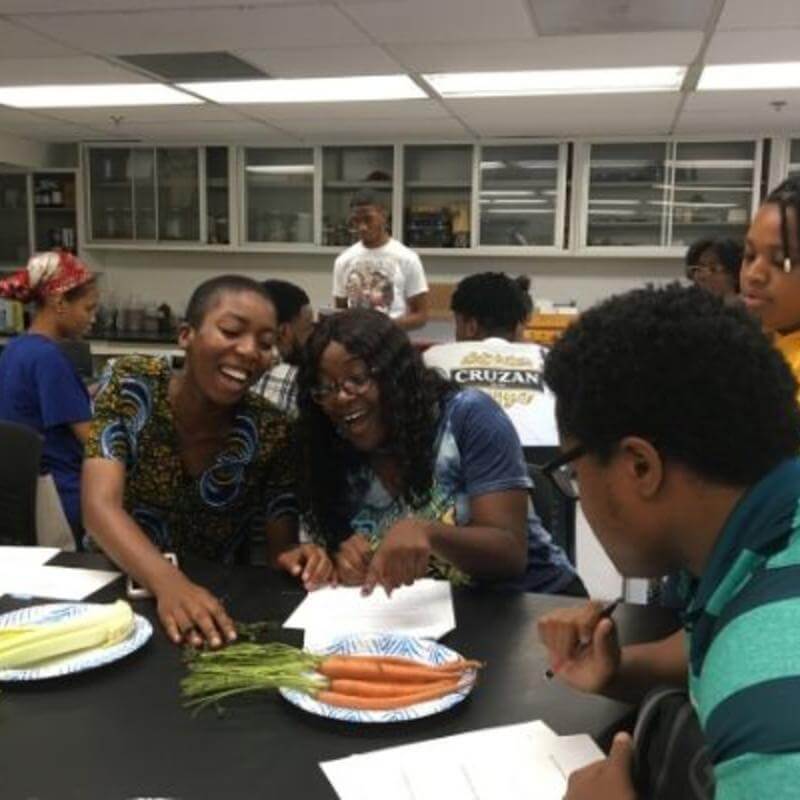 ES Students Examining Fresh Grown Carrots