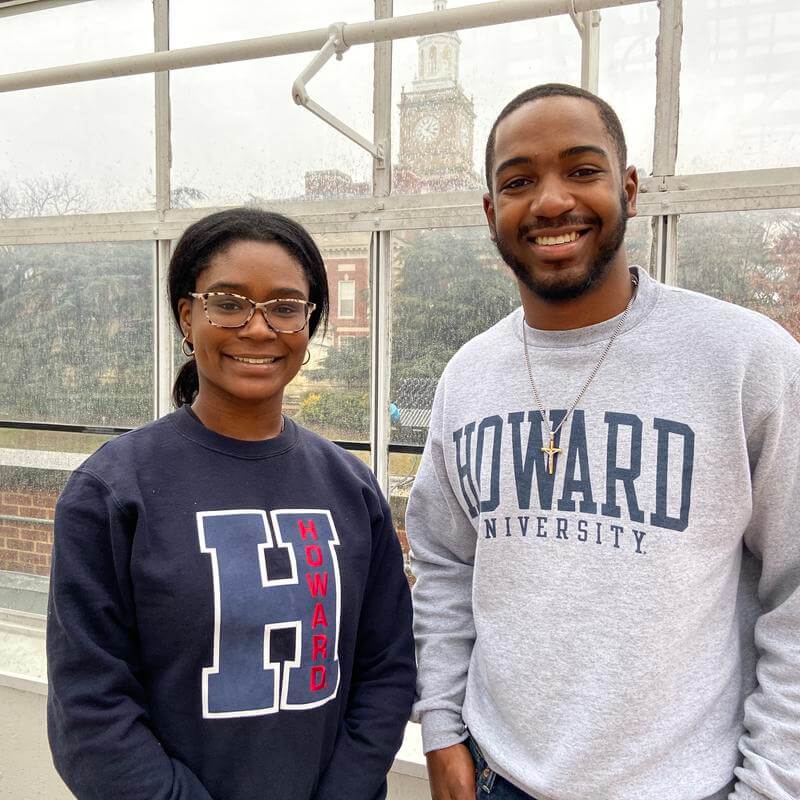 Environmental Studies students Ziyan Spears and Alexandra Grayson are wearing Howard sweatshirts and smiling at the camera.